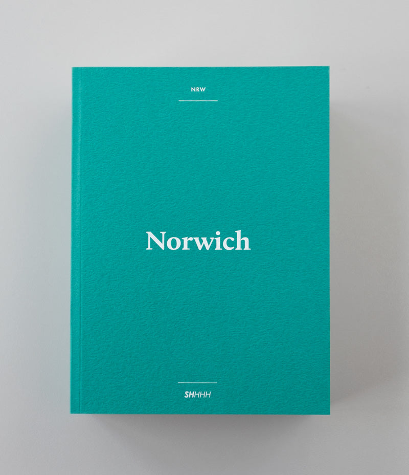 Image shows a teal coloured Norwich Shhhh City Guide 2019 against a grey background - Nor–Folk